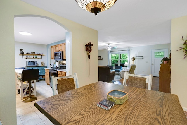 49 Hampton Ln, Hayesville, NC 28904 - dining room featuring arched walkways, ceiling fan, and light tile patterned flooring