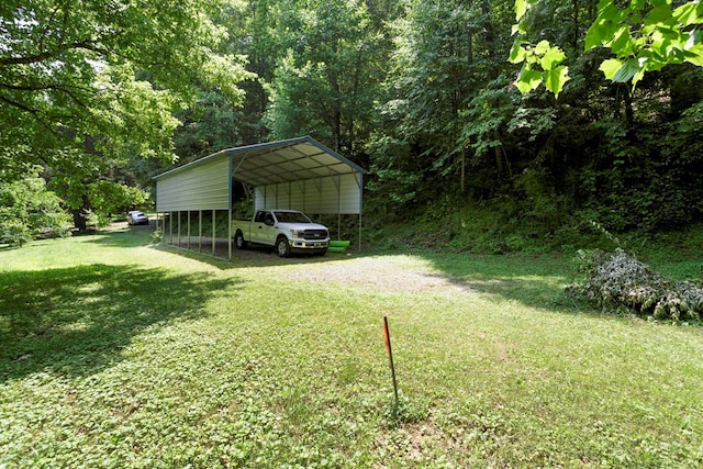 49 Hampton Ln, Hayesville, NC 28904 - view of green lawn with a detached carport, driveway, and a view of trees