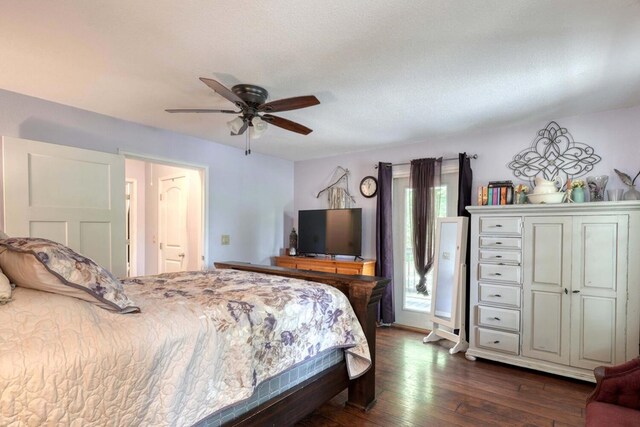 bedroom featuring ceiling fan, dark hardwood / wood-style flooring, and a textured ceiling