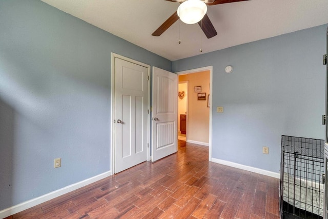 empty room with wood-type flooring and ceiling fan