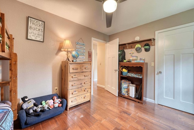 bedroom with ceiling fan and wood-type flooring