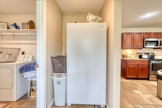 washroom featuring a textured ceiling and washer / clothes dryer