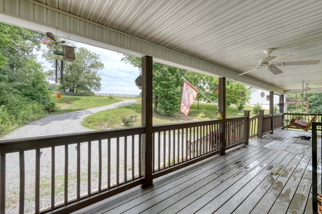 deck with ceiling fan and a yard