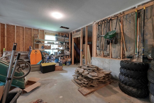 interior space with a textured ceiling and concrete floors