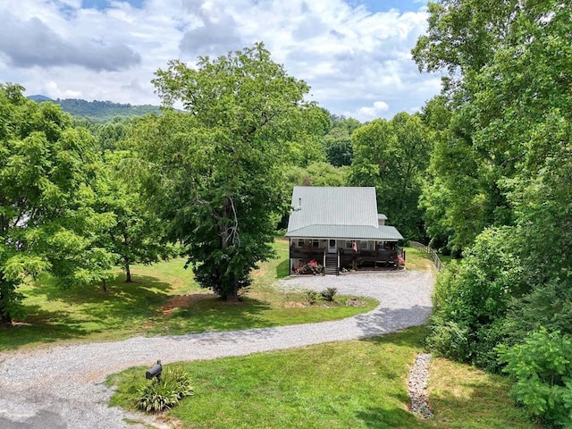 surrounding community with a carport and a lawn