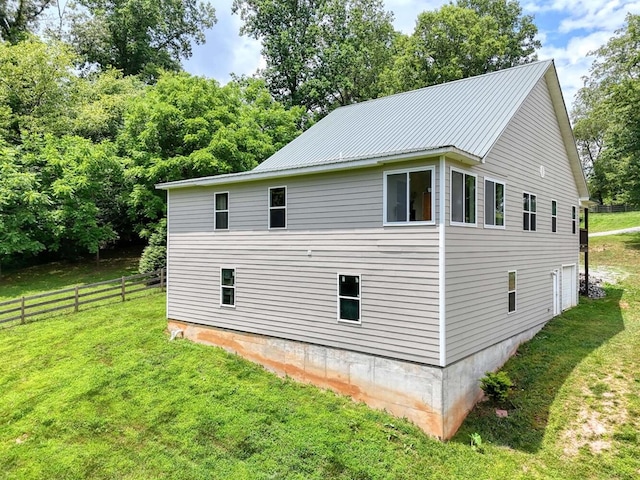 view of side of home with a lawn