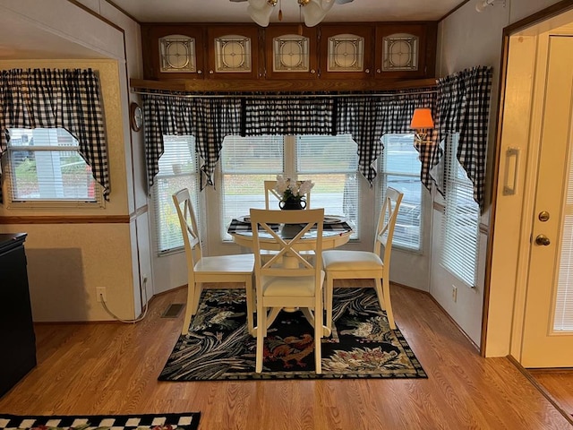 dining area with visible vents, ceiling fan, and light wood finished floors