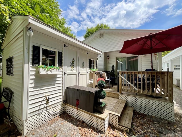 back of property with a wooden deck