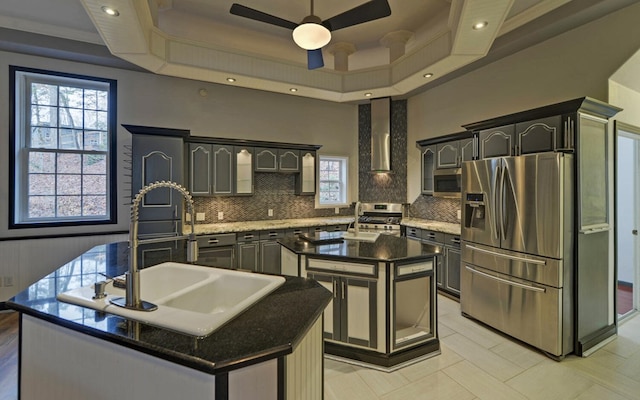 kitchen with plenty of natural light, sink, an island with sink, and appliances with stainless steel finishes