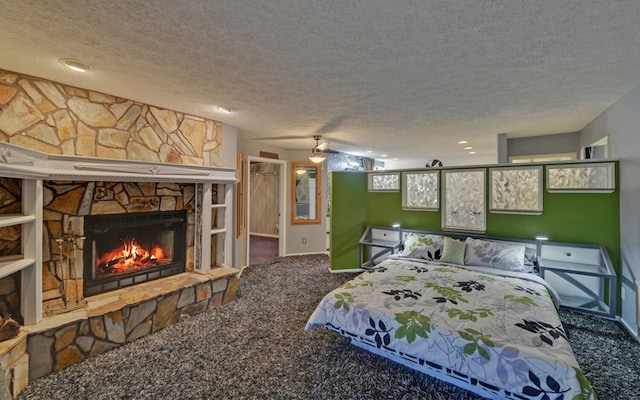 bedroom featuring carpet flooring, a fireplace, and a textured ceiling