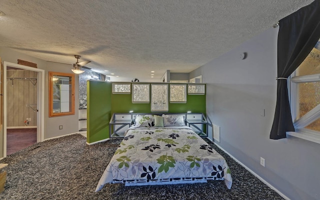 carpeted bedroom with ceiling fan and a textured ceiling