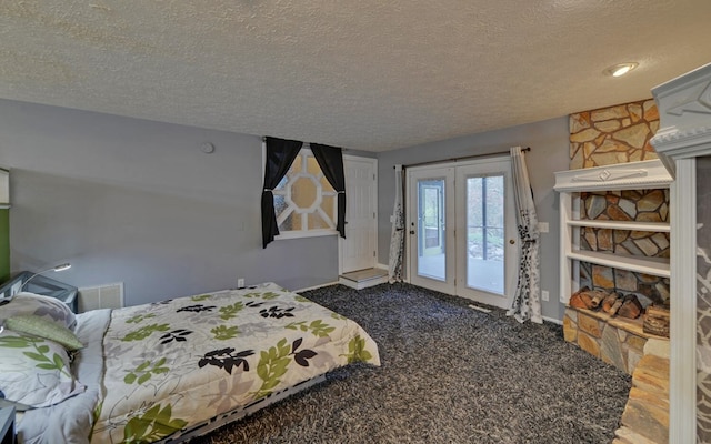 bedroom with carpet, a textured ceiling, and access to outside