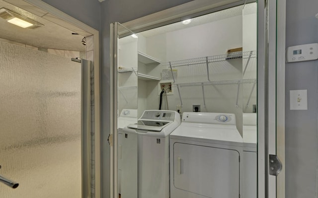 washroom with washer and dryer