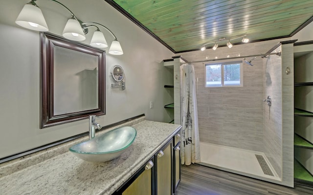 bathroom featuring curtained shower, hardwood / wood-style floors, vanity, wood ceiling, and ornamental molding