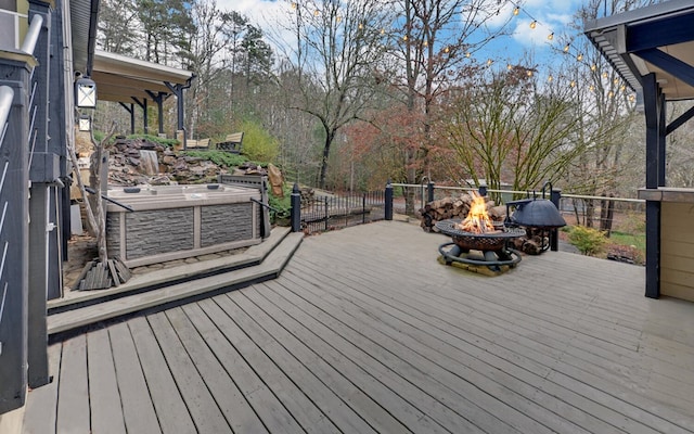 wooden deck with an outdoor fire pit