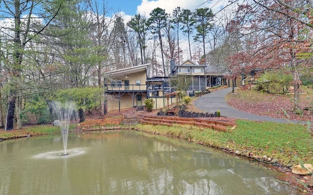 rear view of property with a water view