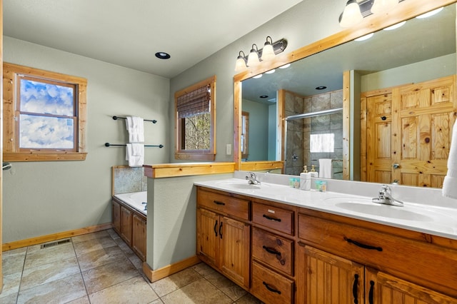 bathroom with shower with separate bathtub, vanity, and tile patterned floors