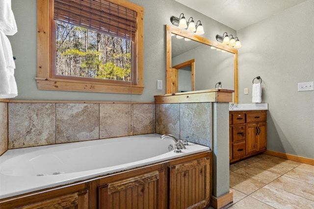 bathroom featuring tile patterned flooring, vanity, and a washtub