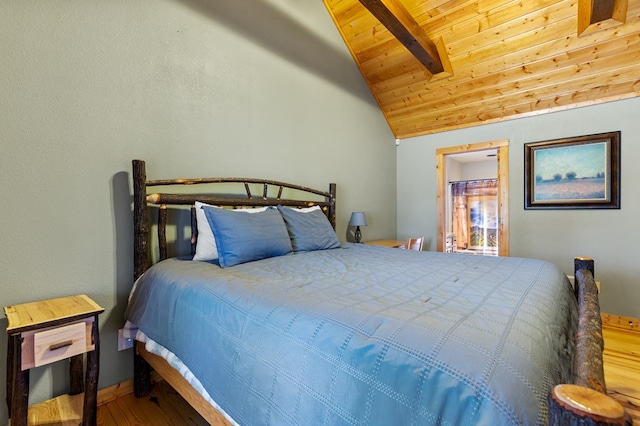 bedroom with lofted ceiling with beams, wood-type flooring, and wooden ceiling