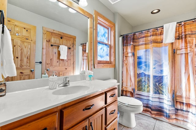 bathroom featuring vanity, tile patterned floors, and toilet