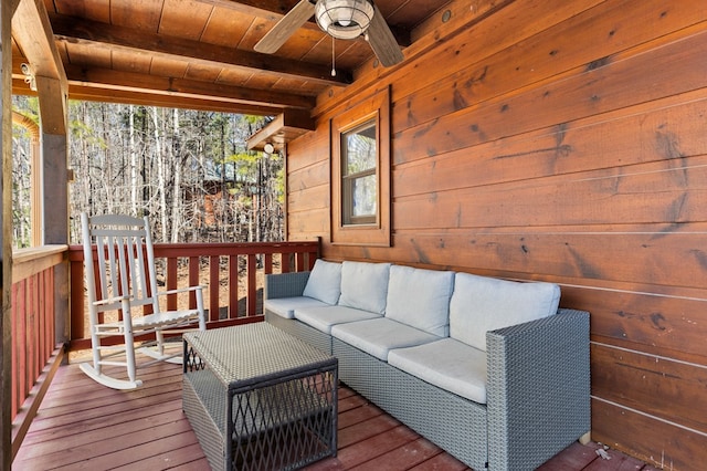 wooden deck with ceiling fan and outdoor lounge area