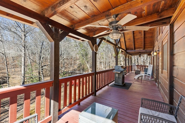 wooden terrace featuring a grill and ceiling fan