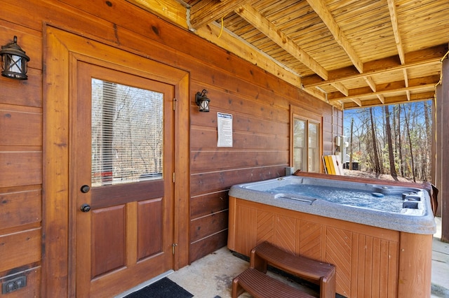 sunroom / solarium featuring a hot tub, wooden ceiling, and beam ceiling