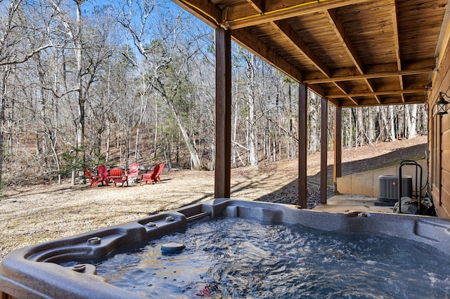 view of patio with a hot tub and central AC