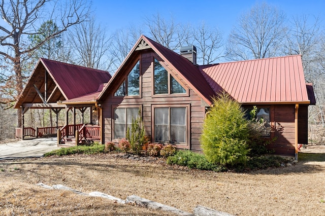 back of property featuring covered porch