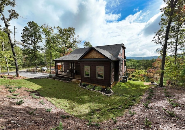 rear view of house featuring a lawn