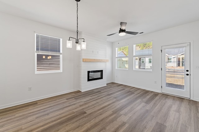 UNIT2 Grove Loop, Blue Ridge, GA 30513 - unfurnished living room with wood finished floors, a ceiling fan, a large fireplace, and baseboards