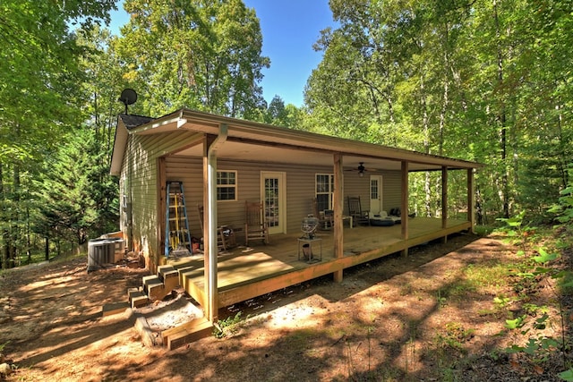 back of property with ceiling fan, a wooden deck, and central AC