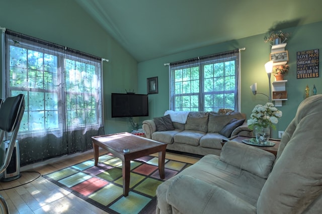 living room with vaulted ceiling and hardwood / wood-style floors