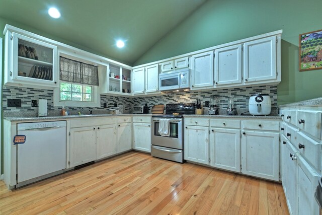 kitchen featuring light hardwood / wood-style floors, decorative backsplash, white appliances, and white cabinets