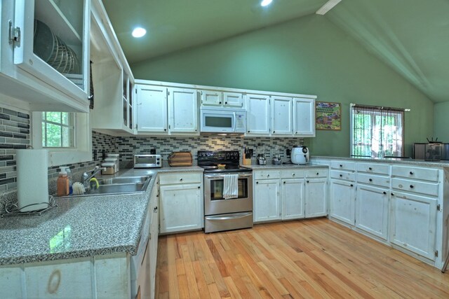 kitchen featuring decorative backsplash, light hardwood / wood-style floors, white cabinetry, sink, and electric range