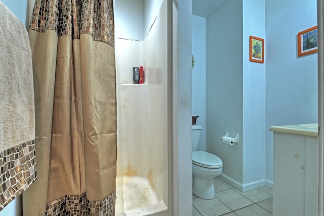 bathroom with walk in shower, vanity, toilet, and tile patterned floors