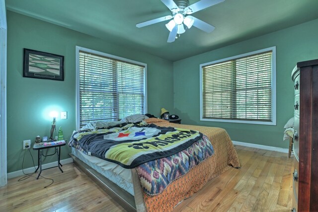 bedroom featuring light wood-type flooring and ceiling fan