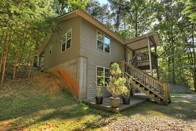 view of side of property featuring a wooden deck