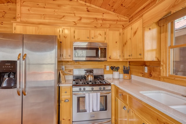 kitchen with a sink, light countertops, stainless steel appliances, vaulted ceiling, and wood ceiling