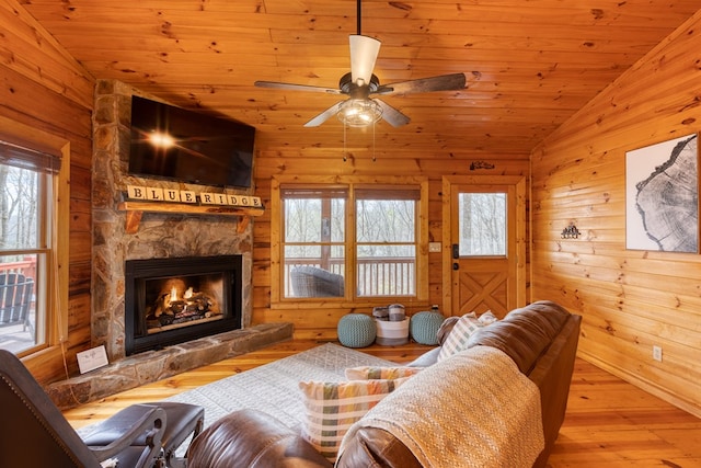 living area featuring plenty of natural light, a fireplace, and vaulted ceiling