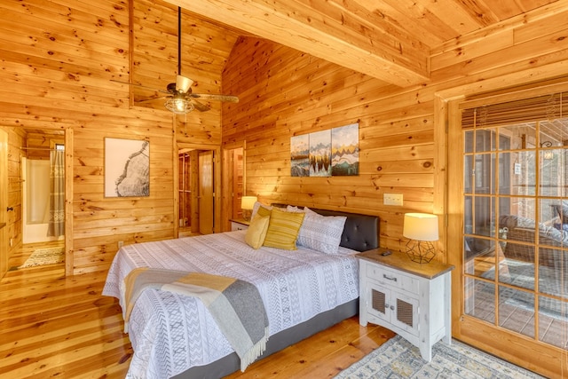 bedroom with wood ceiling, wood walls, hardwood / wood-style floors, and lofted ceiling