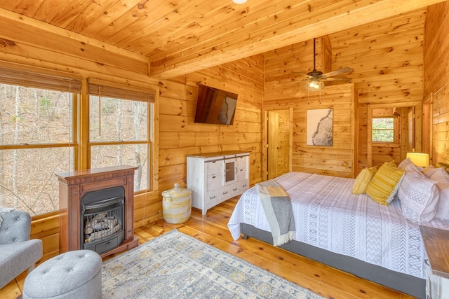 bedroom with wood-type flooring, wood ceiling, and wooden walls