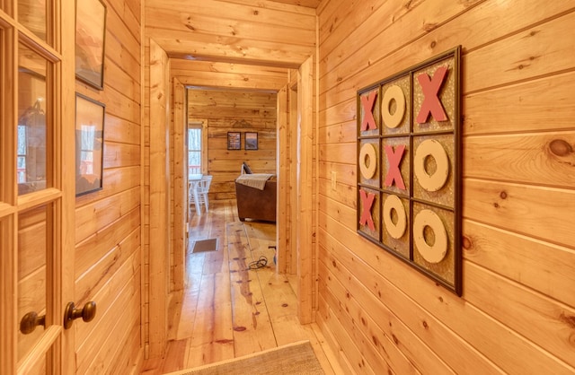 corridor featuring wooden walls and hardwood / wood-style flooring