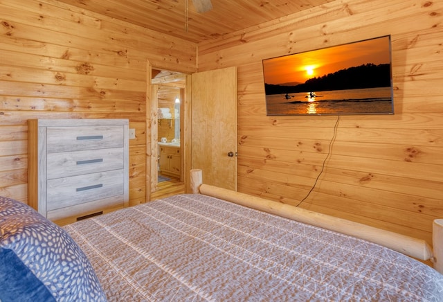 bedroom with wooden walls and wood ceiling