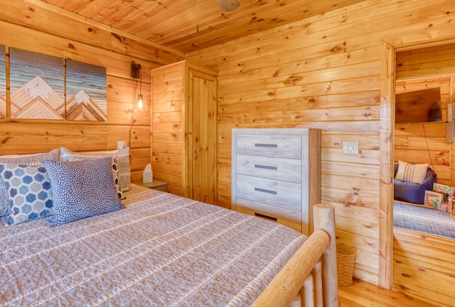 bedroom featuring wooden walls, wooden ceiling, a sauna, and wood finished floors