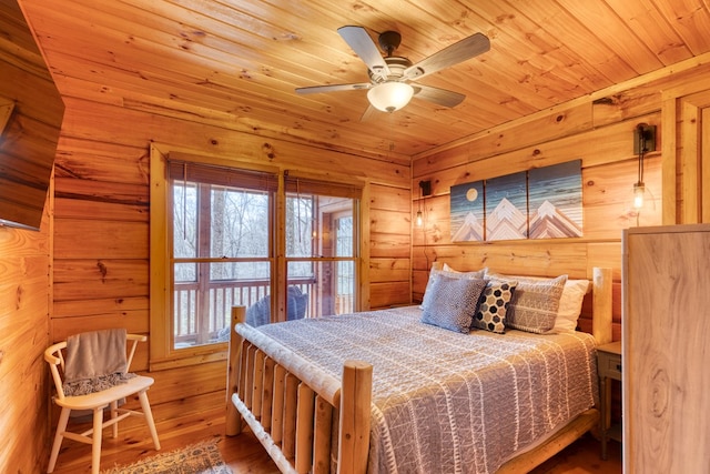 bedroom with wooden walls, wood ceiling, and hardwood / wood-style floors