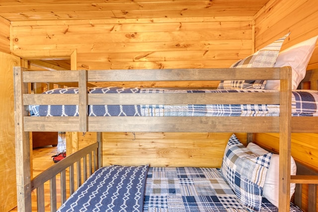 bedroom featuring wooden walls and a sauna
