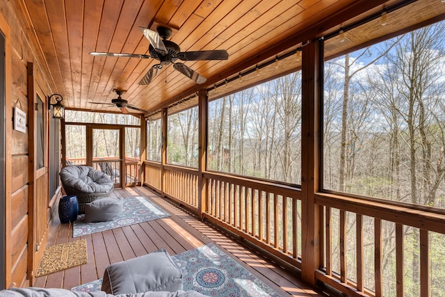 sunroom featuring a ceiling fan and a healthy amount of sunlight