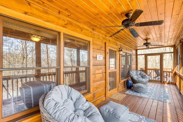 sunroom featuring ceiling fan and a wealth of natural light