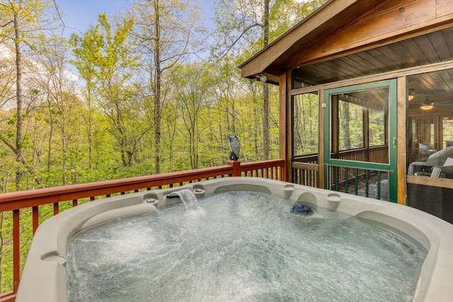 wooden deck featuring a hot tub